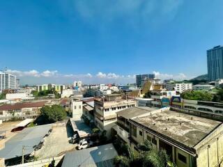 Urban landscape view from a property showcasing various buildings under a clear sky