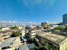 Urban landscape view from a property showcasing various buildings under a clear sky