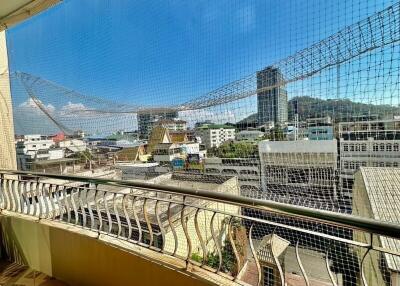 Sunny balcony with protective netting and city view