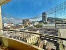 Sunny balcony with protective netting and city view