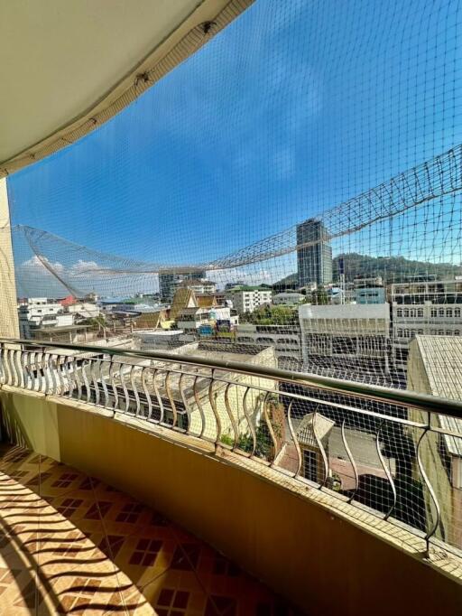 Sunny balcony with protective netting and city view