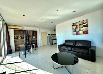 Spacious and well-lit living room with kitchen and dining area