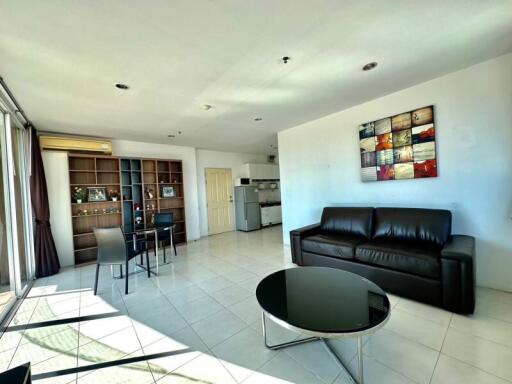 Spacious and well-lit living room with kitchen and dining area