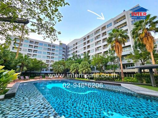 Luxurious outdoor swimming pool in a residential apartment complex with lush greenery