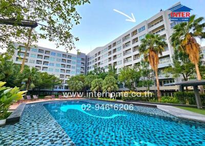 Luxurious outdoor swimming pool in a residential apartment complex with lush greenery