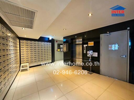 Modern apartment building mailroom with secure mailboxes and entry system