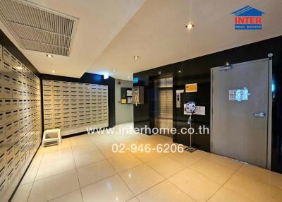 Modern apartment building mailroom with secure mailboxes and entry system