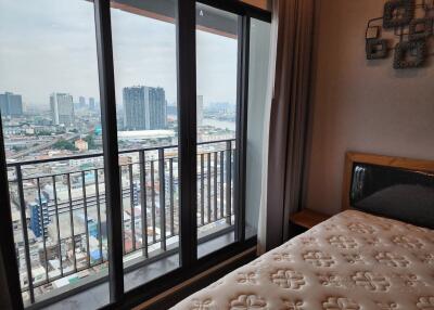 Modern bedroom with city view from large windows