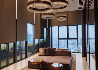 Elegant living room with modern chandeliers and panoramic city views