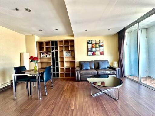 Spacious living room with bookshelf and large windows