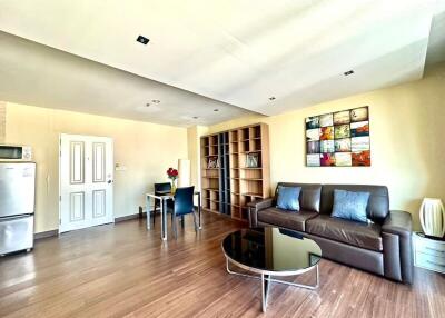 Spacious living room with modern furniture and integrated kitchen