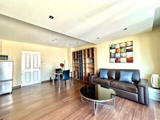 Spacious living room with modern furniture and integrated kitchen