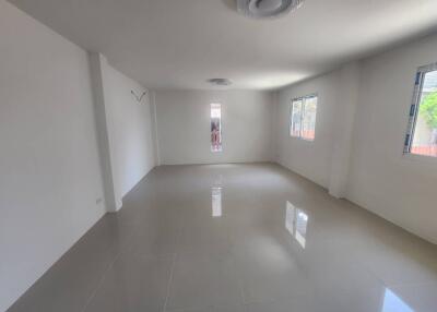 Spacious and Bright Empty Room with Large Windows and Glossy Floor