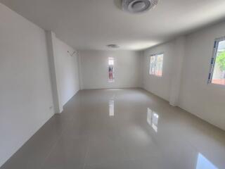 Spacious and Bright Empty Room with Large Windows and Glossy Floor