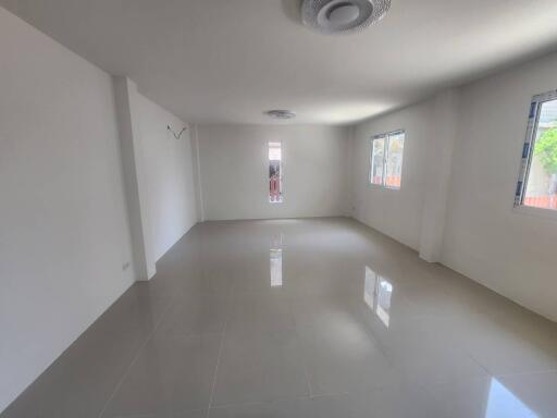 Spacious and Bright Empty Room with Large Windows and Glossy Floor