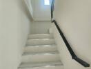 Bright and clean staircase with natural lighting from a window