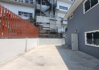 View of the outdoor parking area with adjacent buildings