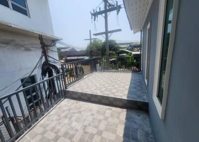 Spacious balcony with tiled flooring and urban view