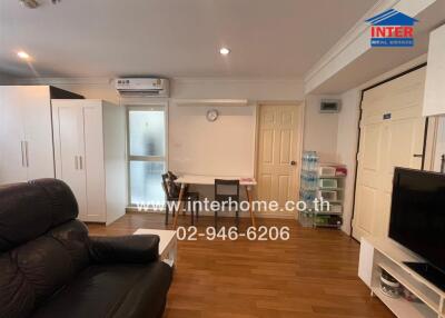 Spacious and well-lit living room with comfortable seating and ample storage
