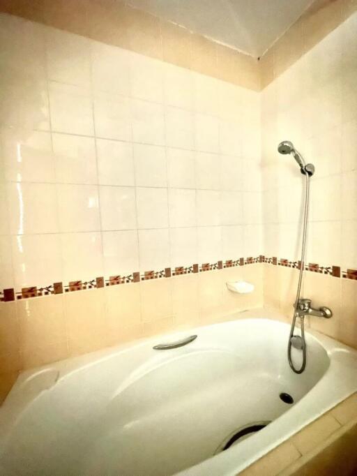 Spacious bathroom with a modern bathtub and decorative tiling