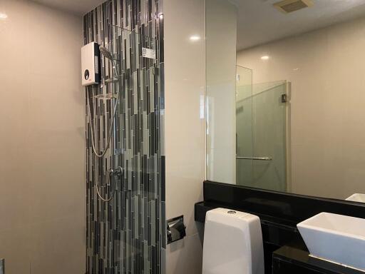 Modern bathroom with glass shower and stylish vertical tiles