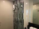 Modern bathroom with glass shower and stylish wall tiles