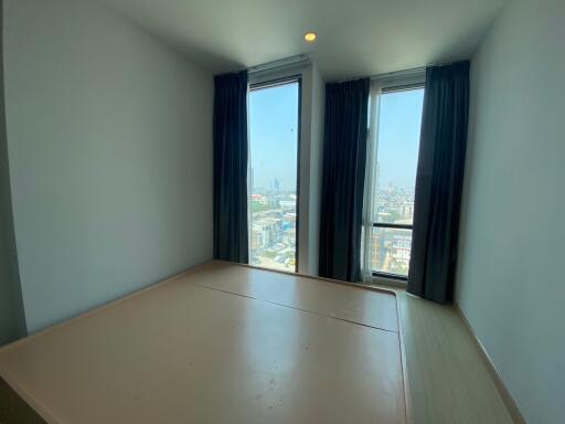 Minimalist bedroom with large windows and city view