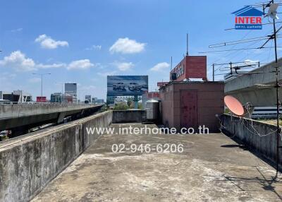 urban rooftop view beside highway with visible commercial billboards