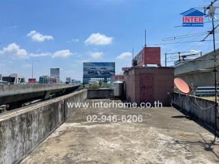 urban rooftop view beside highway with visible commercial billboards