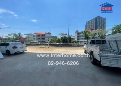 Spacious outdoor parking area with surrounding buildings