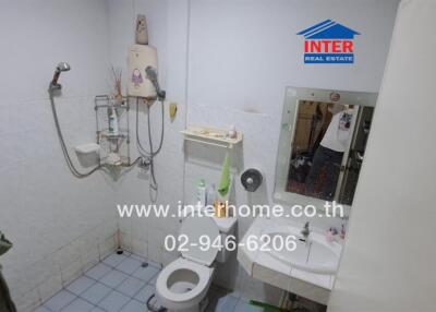 Compact bathroom with white fittings and shower