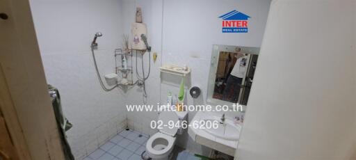 Compact bathroom with white fittings and shower