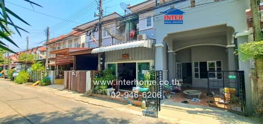 Exterior view of townhouses in a sunny residential area