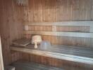 Interior wooden sauna with benches and ladle