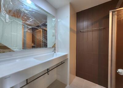 Modern bathroom with spacious sink and wooden cabinet