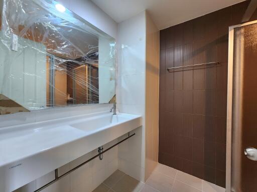 Modern bathroom with spacious sink and wooden cabinet