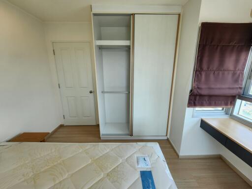 Spacious and bright bedroom with a large window and built-in wardrobe