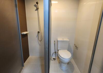 Modern bathroom with glass shower enclosure and toilet