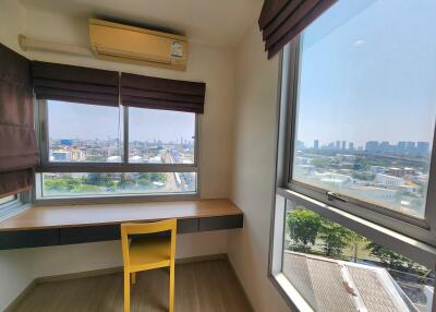 Bright bedroom with large window and city view