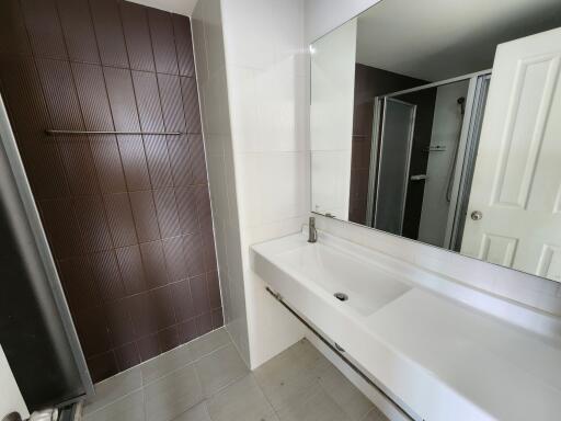 Modern bathroom interior with a large mirror and white sink