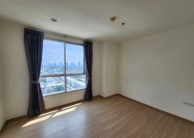 Spacious bedroom with large window and city view