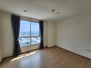 Spacious bedroom with large window and city view