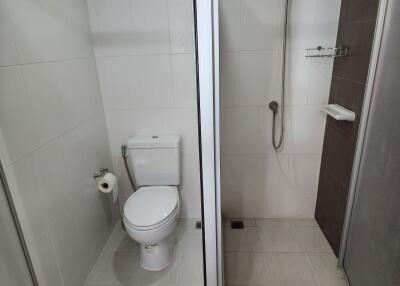 Modern bathroom with glass shower stall and white tiles