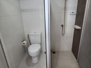 Modern bathroom with glass shower stall and white tiles