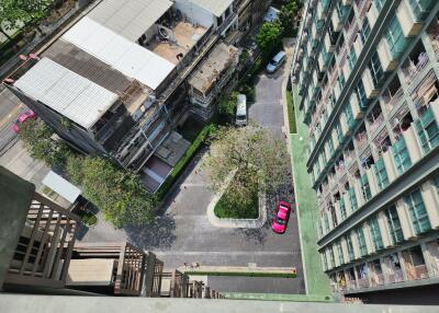 High-angle view from a building balcony showcasing structures below