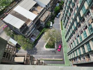 High-angle view from a building balcony showcasing structures below