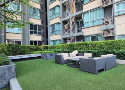 Modern outdoor common area in residential apartment complex with seating