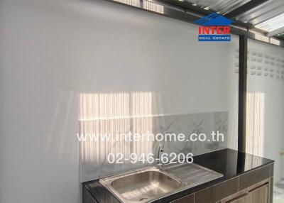 Modern kitchen with stainless steel sink and ample sunlight