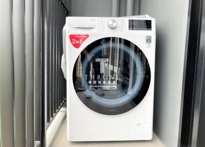 Modern white washing machine in the laundry area of a residential home