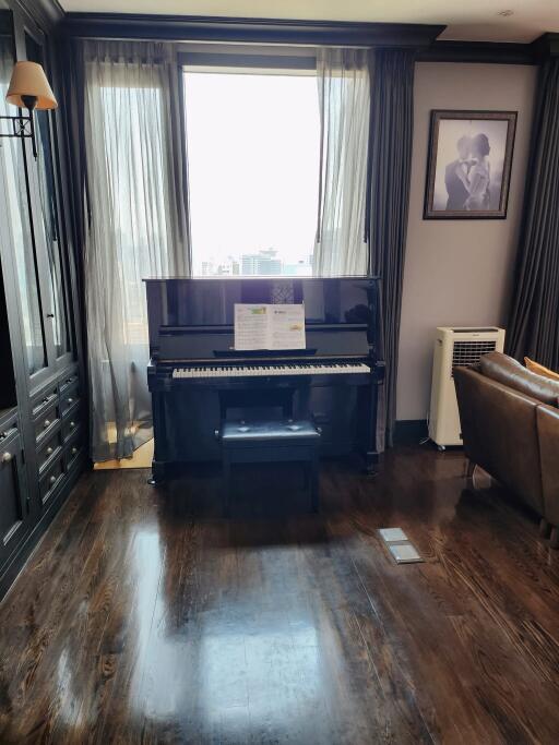 Elegant living room with piano and hardwood flooring